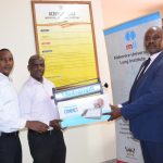From the right, Simon Mugambe Head of Operations Makerere University Lung Institute, Dr Ivan Kimuli head Clinical Services Makerere University Lung Institute hand over a Vitalograph Machine to Dr Charles Kabugo the Director Kiruddu National Referral Hospital in Kampala on 27th February 2024